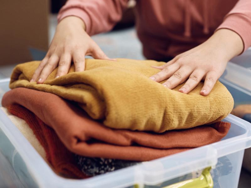 Person packing dry clothes