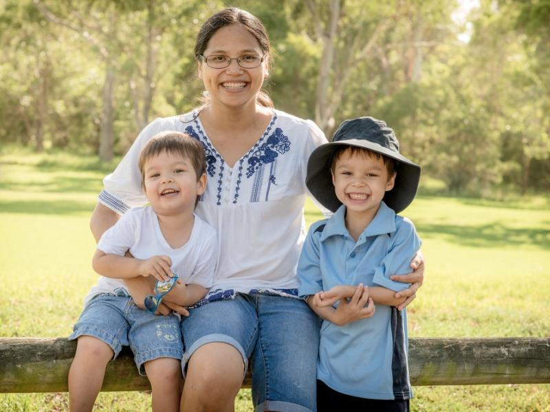 woman and two children smiling